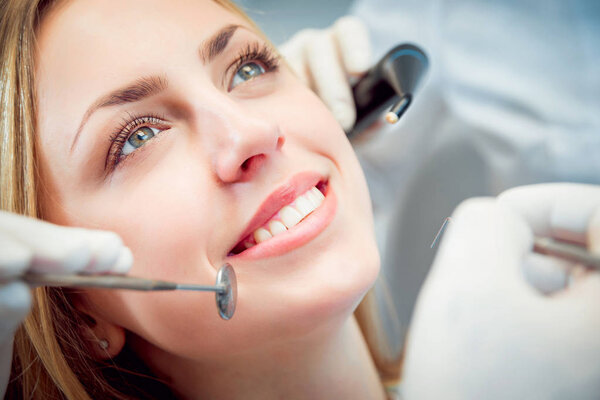 Young smiled woman at the dental office. Medical equipment
