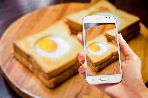 Toast bread with egg inside on the board. The Restaurant