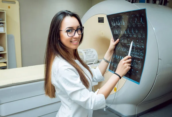 Young female middle eastern doctor in MRI room. Medical equipment.