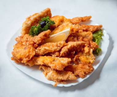 Fried meat on white plate. 