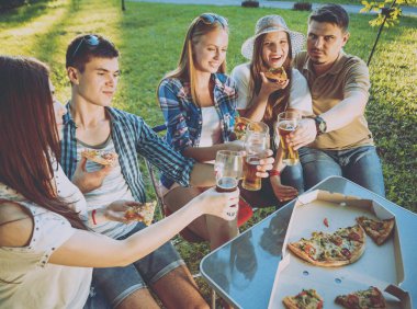 Parkta piknik neşeli arkadaşlar. Gülümseyen ve söz.