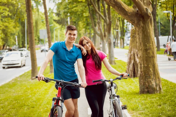 Jovem Casal Caucasiano Ciclismo Pista Bicicleta Verde Dia Ensolarado — Fotografia de Stock