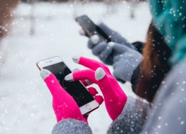 Dokunmatik ekranlar için eldiven ile kışın Smartphone kullanarak çift.