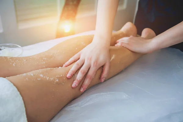 Young girl is relaxing in the spa. Legs massage.