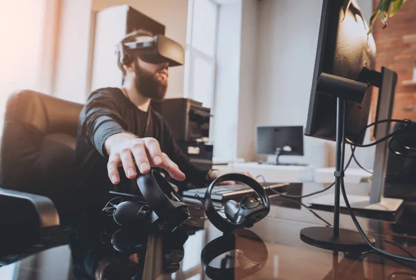stock image Young man wearing virtual reality goggles at the office.