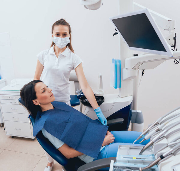 Female dentist and a patient at the dental office