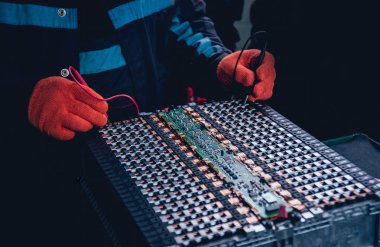 Elecric motorlu pilleri şarj. Pil bir elektrikli araç motorunun sökülmesi. Araba Servisi