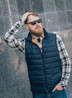 Yakışıklı adam açık havada kameraya poz rahat kıyafetler içinde sakallı