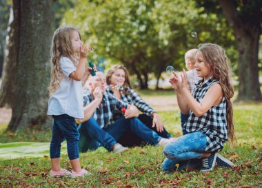 Büyük genç aile parkta iyi vakit geçiriyor.