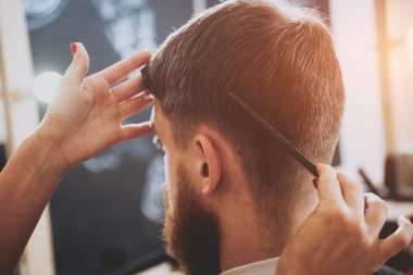 Kuaför saç modeli için genç bir adam yapar..