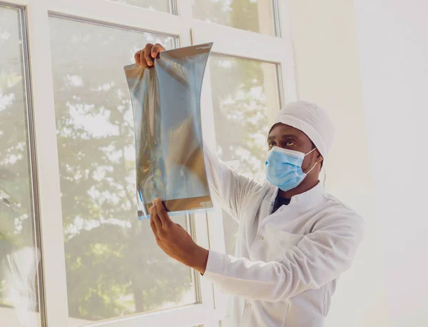 male Black doctor in office