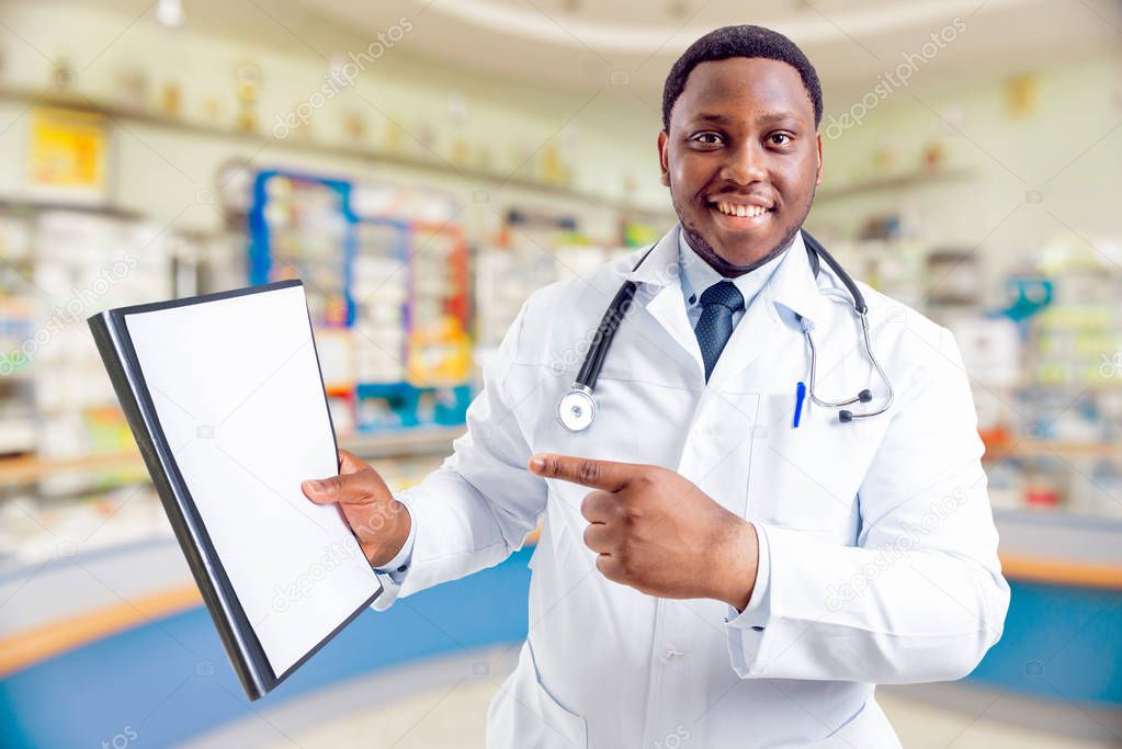 African american doctor at pharmacy. Concept of giving advices about medicaments of pharmacy.