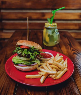Büyük çizburger ve patates kızartması bir plaka üzerinde. Restoran