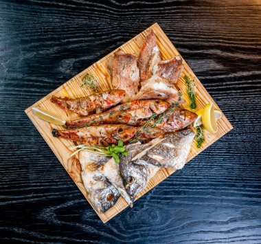 bir ahşap tahta üzerinde kızarmış balık