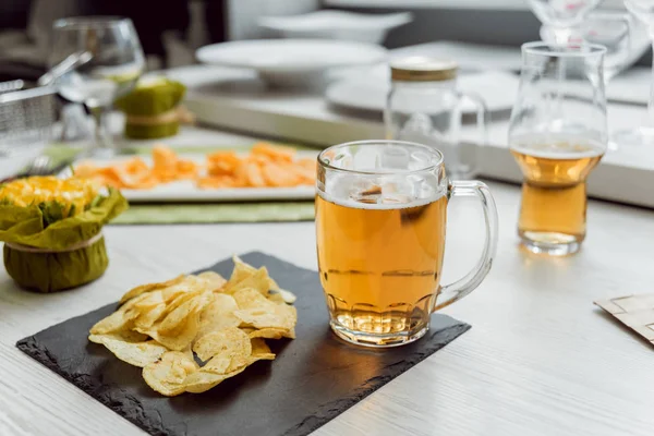 Bira ve büyük beyaz masanın üzerindeki fişlere. Restoran