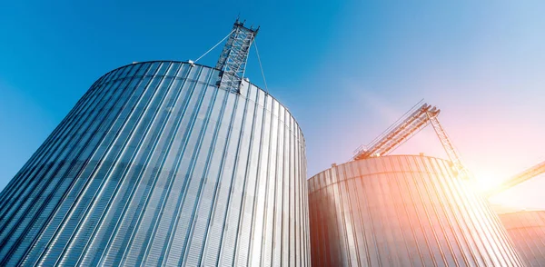 Modern silos for storing grain harvest. Agriculture. Low angle.