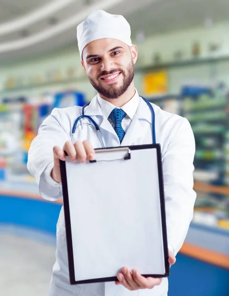 Young doctor with clipping pad. Concept of giving advices about medicaments of pharmacy.