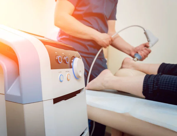 Shock wave therapy. The magnetic field, rehabilitation. Physiotherapist doctor performs surgery on a patients heel — Stock Image Shock Wave Therapy Magnetic Field Rehabilitation Physiotherapist Doctor Performs Surgery Stock Image