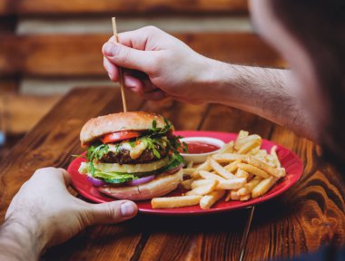 Kırmızı plaka üzerinde yangınları ile büyük ve lezzetli burger.