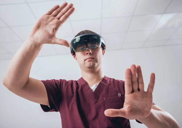 Doctor uses augmented reality goggles. Modern technology