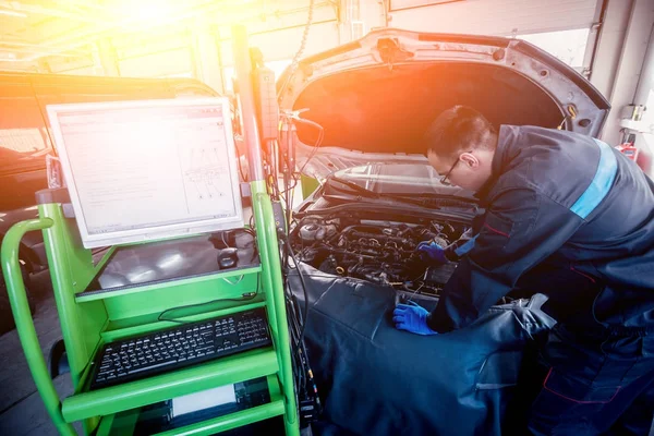 Otomatik onarım hizmetinde çalışan profesyonel araba tamircisi. Motor bilgisayar tanılama