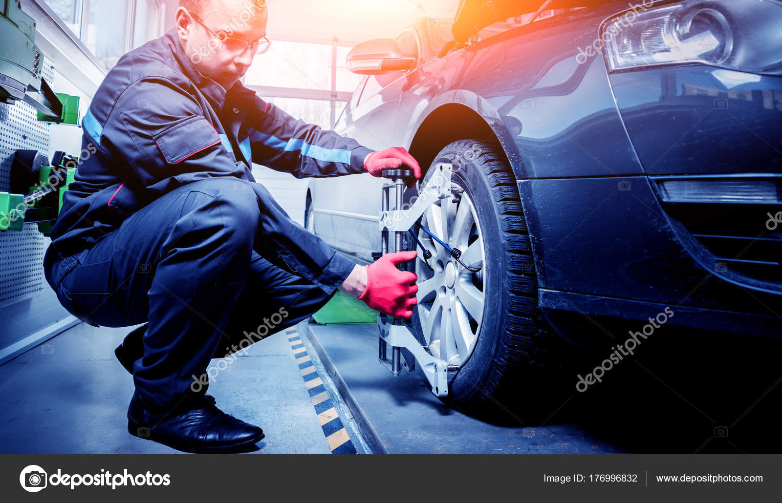 Car Mechanic Installing Sensor Suspension Adjustment Wheel Alignment