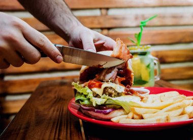 Büyük çizburger ve patates kızartması bir plaka üzerinde. Restoran