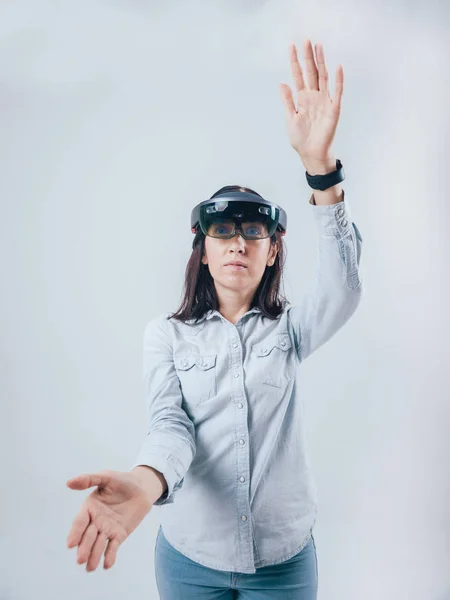 Woman wearing augmented reality goggles, isolated on white