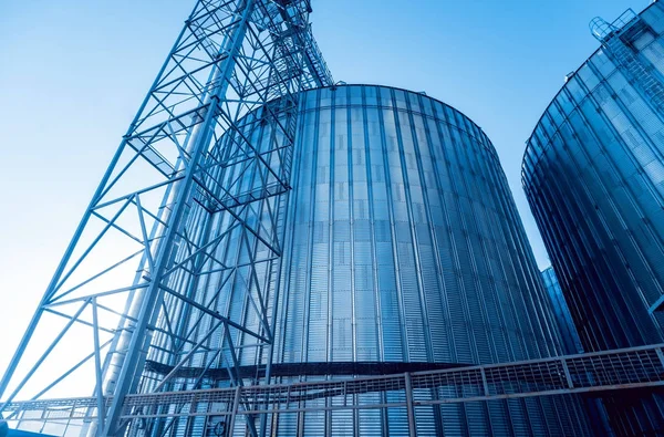 Modern silos for storing grain harvest. Agriculture. Low angle.