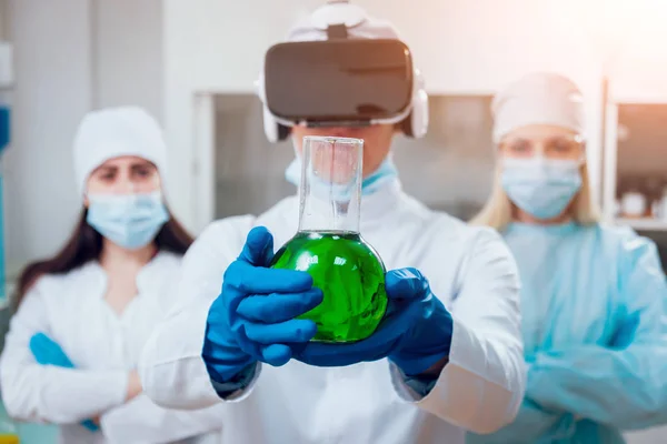 Science technicians in virtual reality glasses examines the drug in laboratory.