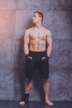 Genç savaşçı Studio gri duvar önce poz