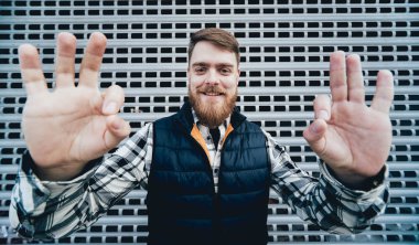 Kameraya poz rahat kıyafetler içinde sakallı yakışıklı.