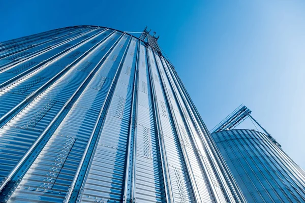 Modern silos for storing grain harvest. Agriculture. Low angle.