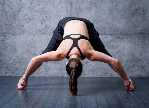 Gri duvar Yoga pratik kadın.