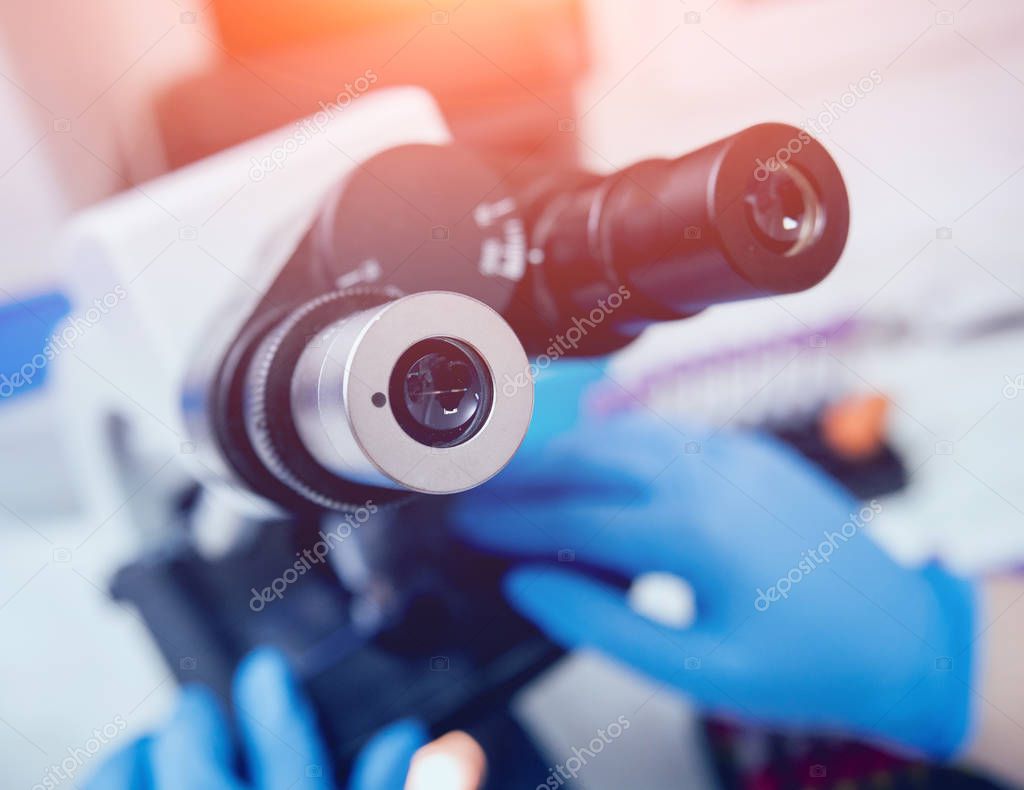 Microscope with metal lens at laboratory. Medical equipment
