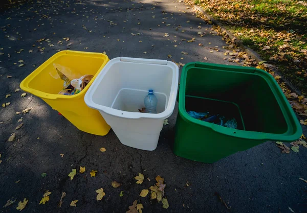 Three trash containers in different color, for sorted waste. Outdoors in the park zone. Zero waste concept — 스톡 사진