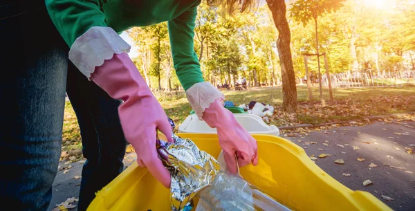 ボランティアの女の子は公園の通りでゴミを分別している。リサイクルの概念。廃棄物ゼロのコンセプト。自然 — ストック写真