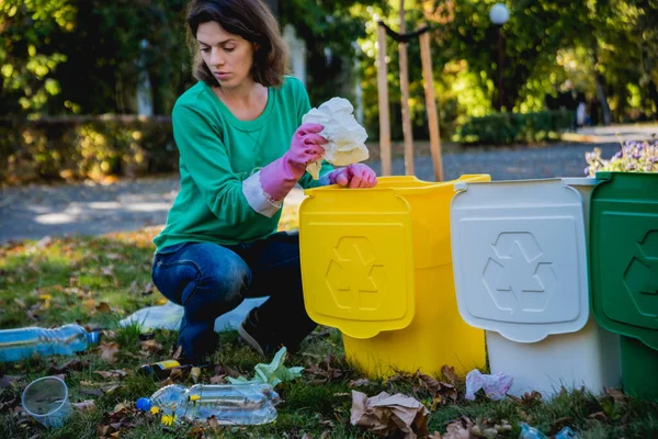 Volunteer girl sorts garbage in the street of the park. Concept of recycling. Zero waste concept. Nature — 스톡 사진