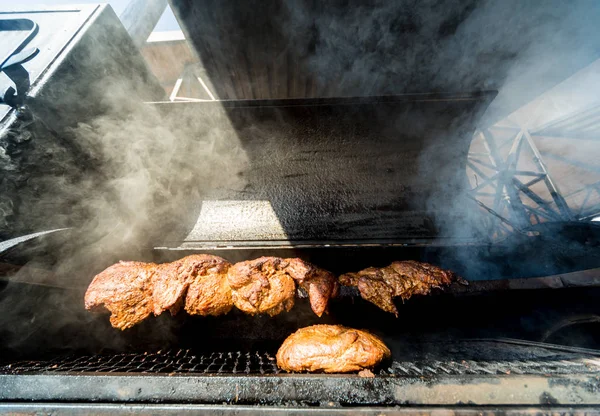 Large barbecue smoker grill at the park. Meat prepared in barbecue smoker. — Stock Photo, Image
