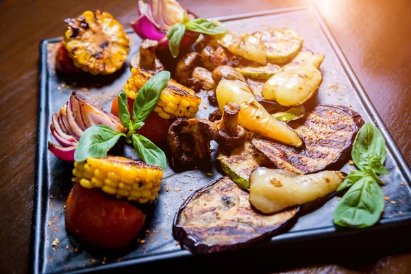 Tasty grilled vegetables on big plate. Healthy food. Restaurant.