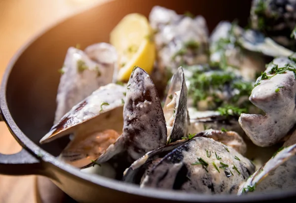 Mussels with garlic white sauce in a bowl. Restaurant