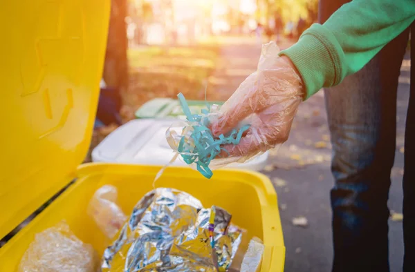 Volontär flicka sorterar skräp på gatan i parken. Begreppet återvinning. — Stockfoto