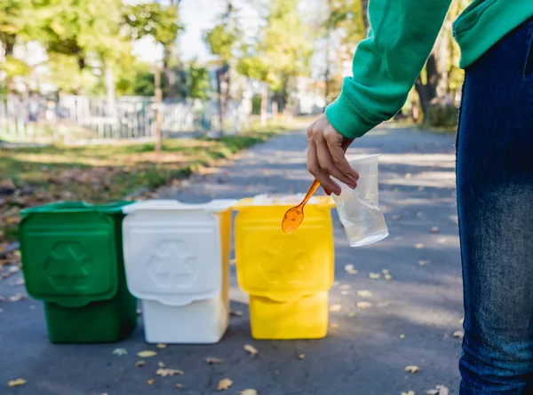 Volunteer girl sorts garbage in the street of the park. Concept of recycling. — 스톡 사진