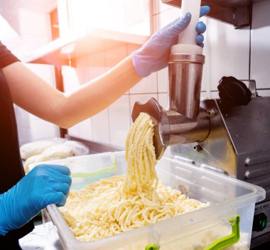 Automatic grater cheese for khachapuri or pizza or pasta. Cooking. 