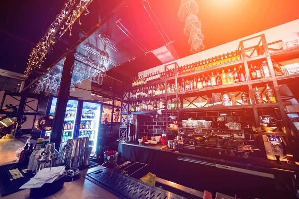 Modern bar counter with bottles and glasses — Stock Photo, Image