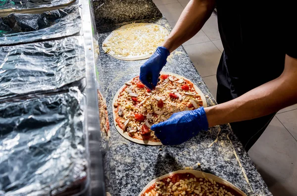 Le processus de fabrication de la pizza. Mains de chef boulanger faire de la pizza à la cuisine du café — Photo