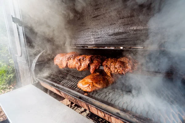 Large barbecue smoker grill at the park. Meat prepared in barbecue smoker. — Stock Photo, Image