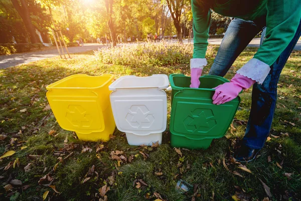 Μια εθελόντρια μαζεύει σκουπίδια στο δρόμο του πάρκου. Έννοια της ανακύκλωσης. — Φωτογραφία Αρχείου