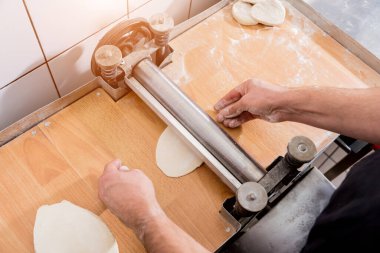 Chef preparing dough for pastry, dumplings, italian pasta or japanese wontons. 