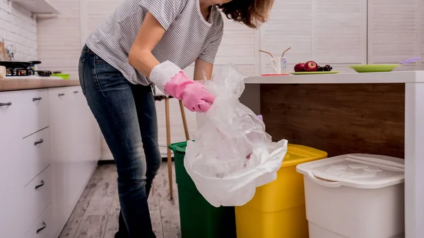 Egy fiatal lány szemetet rendez a konyhában. Az újrahasznosítás fogalma. Zéró hulladék — Stock Fotó
